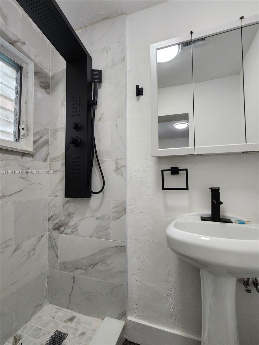 5934 Buchanan Street, Unit 4 Hollywood, FL 33021 - Photo 8 of 8 a bathroom with a sink and mirror