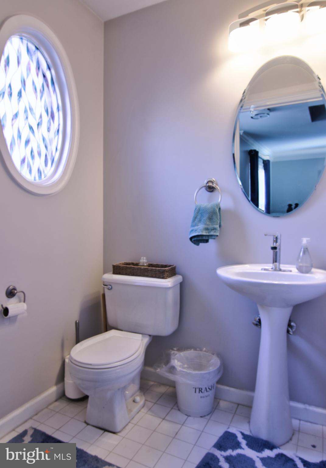 3879 Schroeder Avenue Perry Hall, MD 21128 - Photo 19 of 31 a bathroom with a toilet a sink and mirror