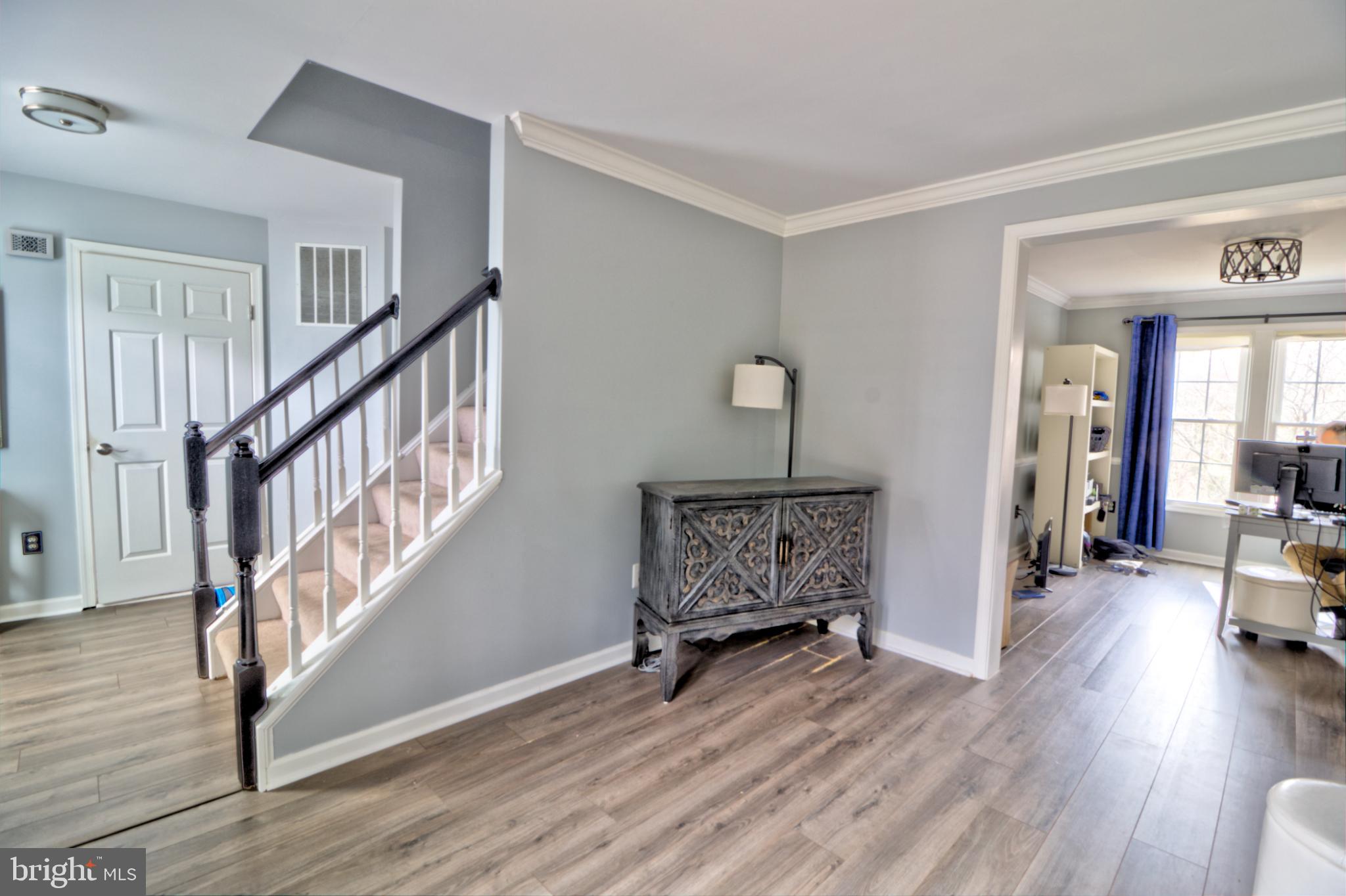 3879 Schroeder Avenue Perry Hall, MD 21128 - Photo 27 of 31 a view of a livingroom with wooden floor and stairs