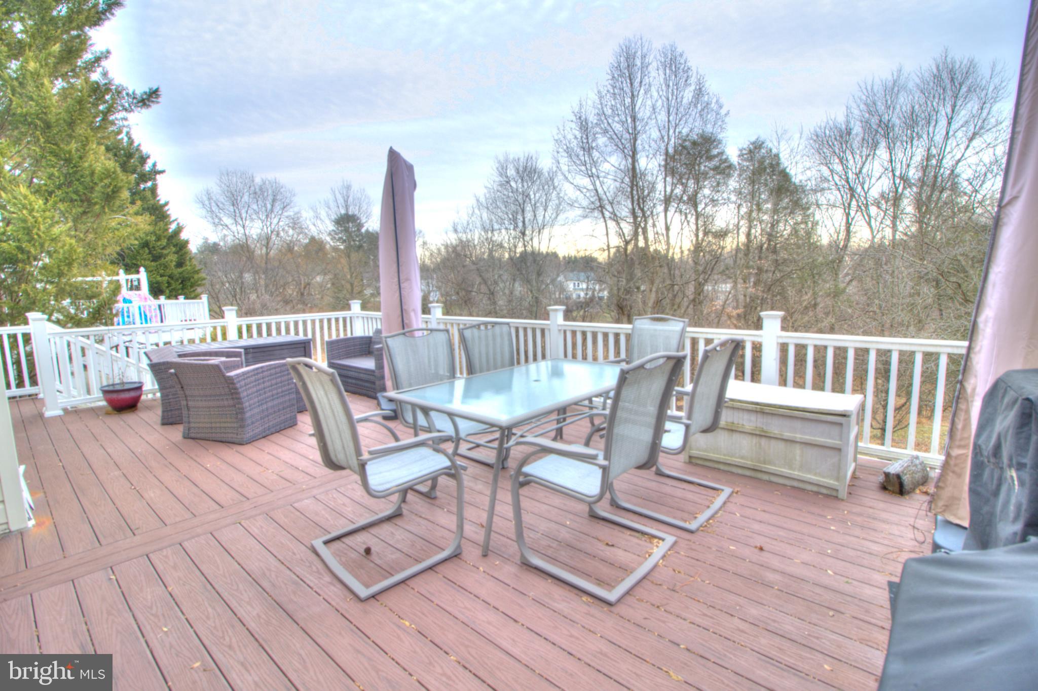 3879 Schroeder Avenue Perry Hall, MD 21128 - Photo 9 of 31 a view of a roof deck with table and chairs couches and wooden floor