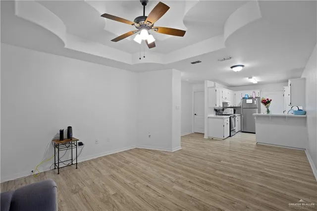 a view of kitchen with wooden floor and a sink