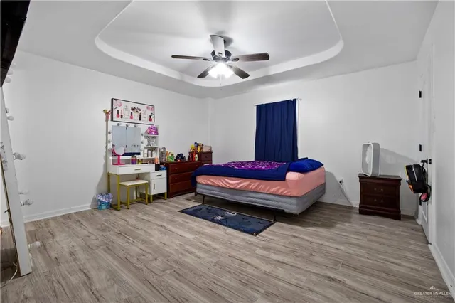 a spacious bedroom with a bed and a chandelier