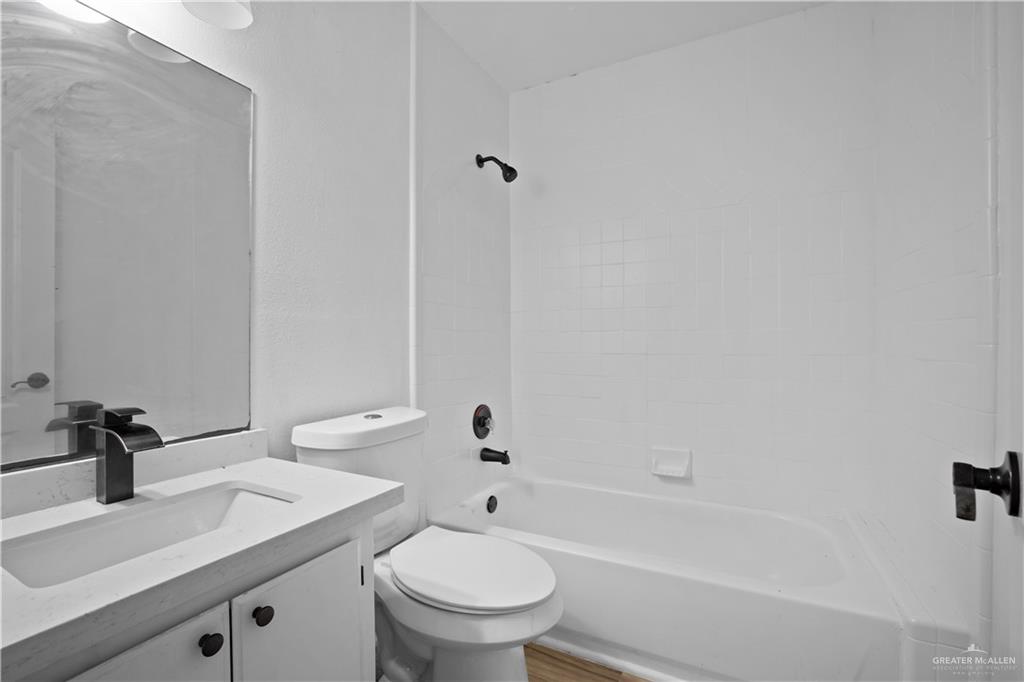 159 North Bridge Avenue Weslaco, TX 78596 - Photo 8 of 19 a bathroom with a sink a toilet and shower