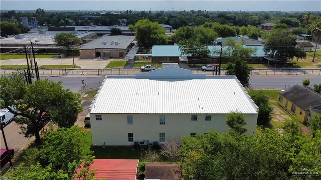 an aerial view of a house with a garden and lake view