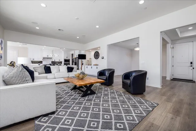 a living room with lots of furniture and a rug