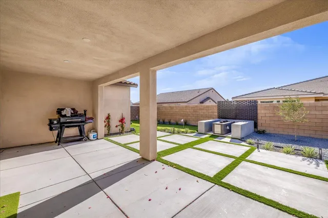 a view of a patio with table and chairs potted plants
