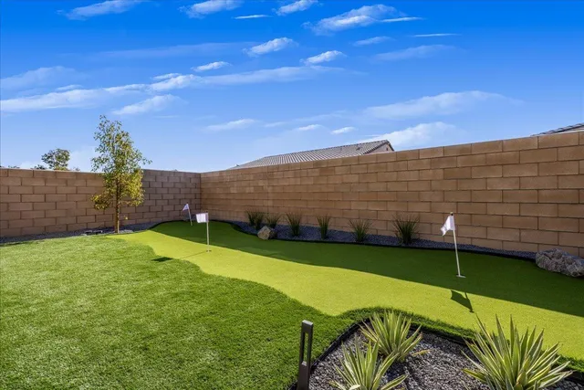 a view of a white house with a swimming pool