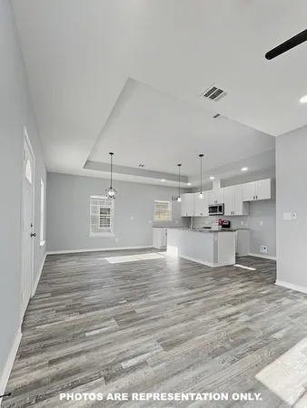 a view of kitchen and kitchen with microwave
