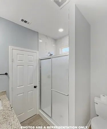 a bathroom with a shower and toilet