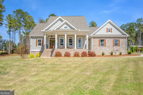 a front view of a house with yard and garage