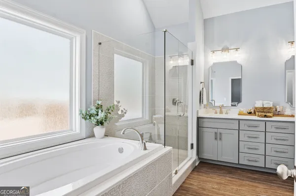 a spacious bathroom with a tub shower and sink