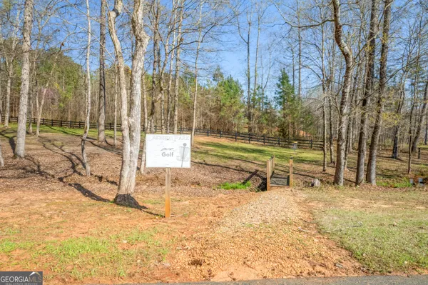 a view of a yard with wooden fence