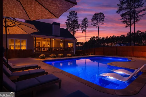 a view of swimming pool with outdoor seating