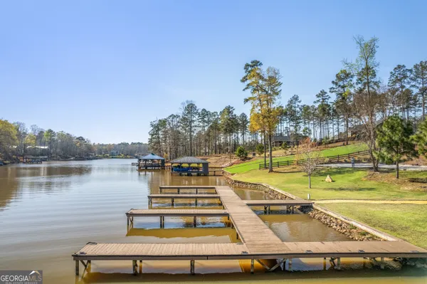 a view of a swimming pool with outdoor seating and lake