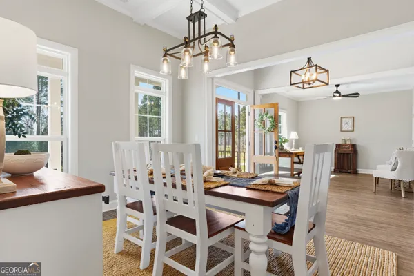 a view of a dining room with furniture and wooden floor