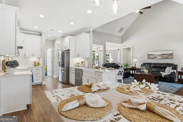 a large kitchen with a table and chairs