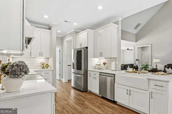 a kitchen with white cabinets and stainless steel appliances
