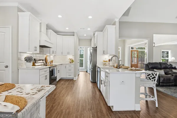 a kitchen with white cabinets and stainless steel appliances
