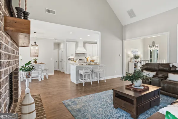a living room with furniture kitchen view and a table