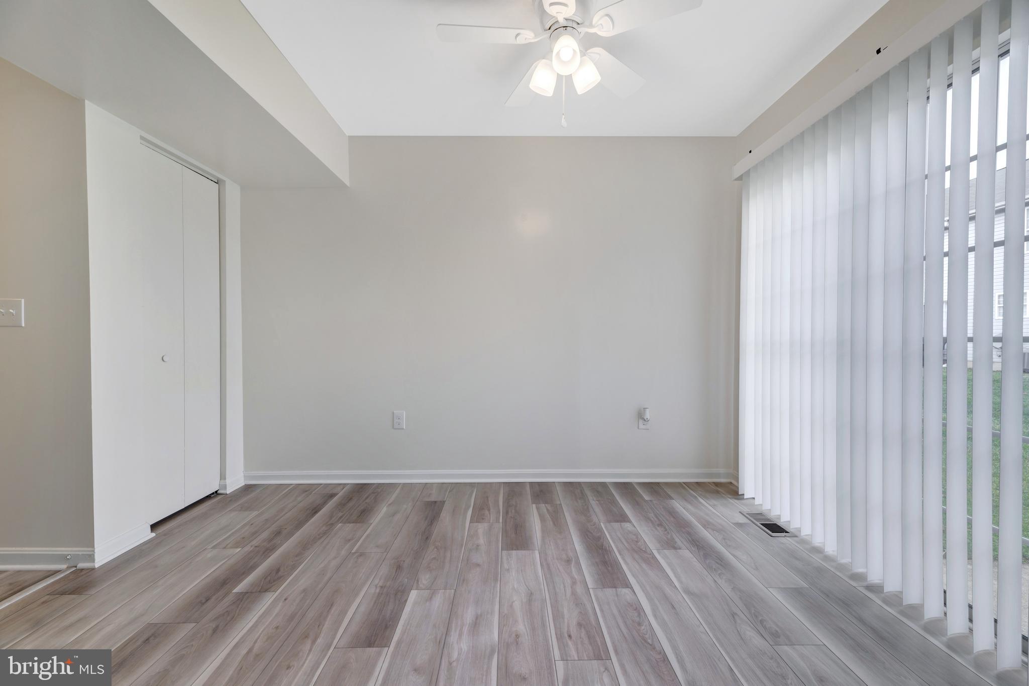 7108 Ruthgreen Road Windsor Mill, MD 21244 - Photo 11 of 25 wooden floor in an empty room with a window