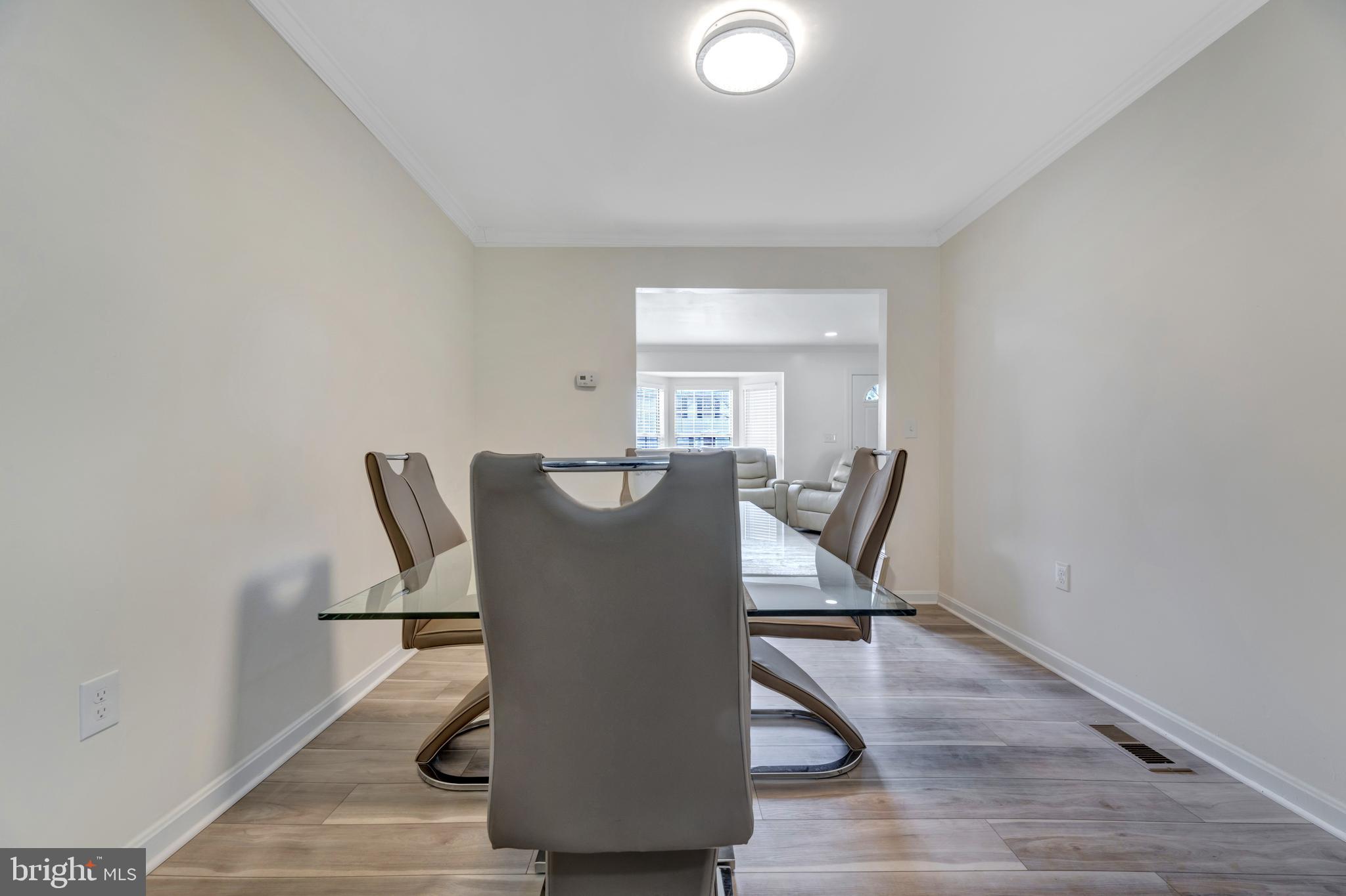 7108 Ruthgreen Road Windsor Mill, MD 21244 - Photo 15 of 25 a view of a dining room with furniture and wooden floor
