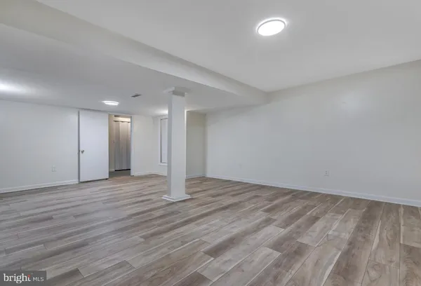 a view of an empty room with wooden floor