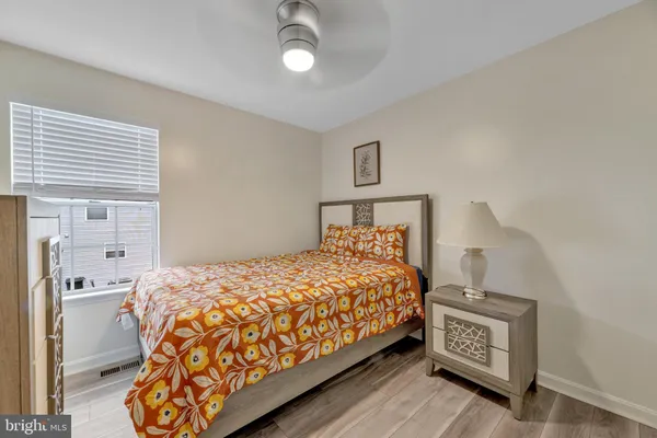 a bedroom with a bed and a night stand