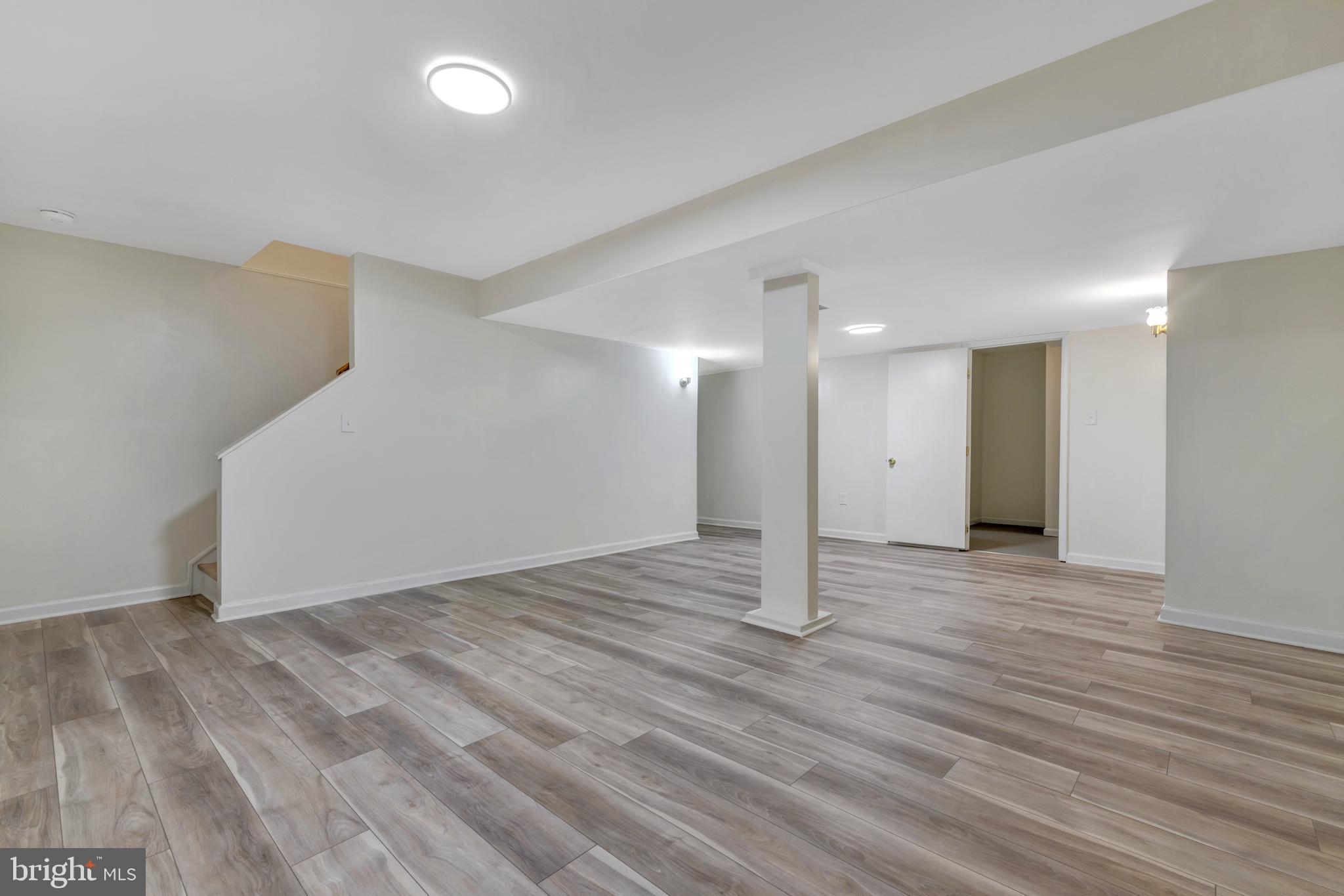 7108 Ruthgreen Road Windsor Mill, MD 21244 - Photo 21 of 25 a view of an empty room with wooden floor