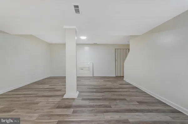 a view of an empty room and wooden floor