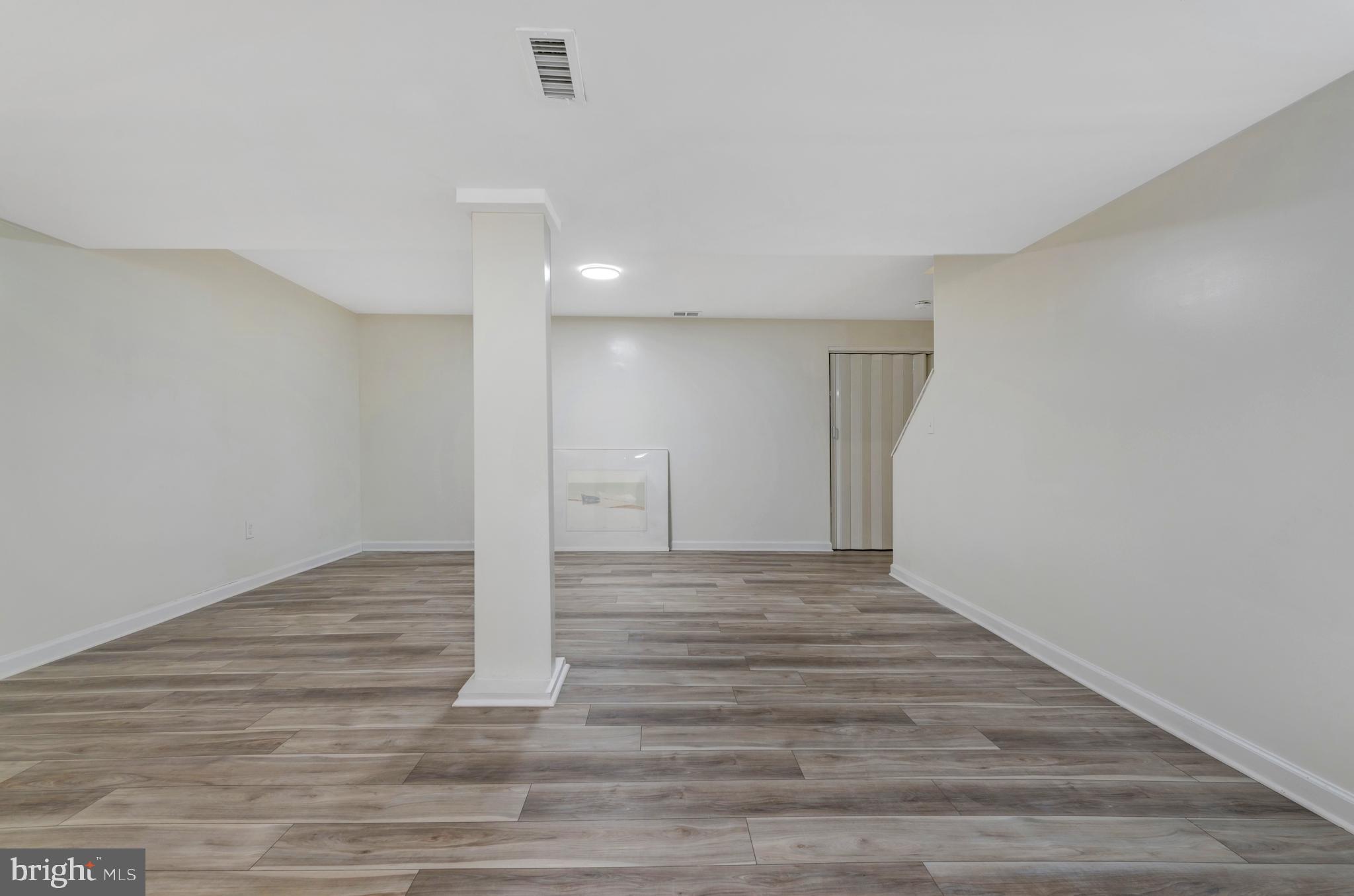 7108 Ruthgreen Road Windsor Mill, MD 21244 - Photo 22 of 25 a view of an empty room and wooden floor