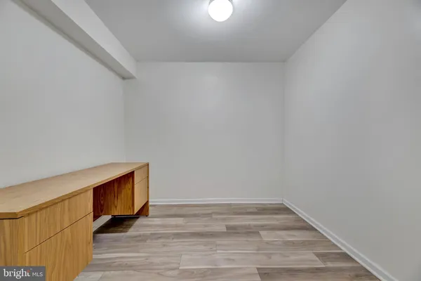 a view of an empty room and wooden floor