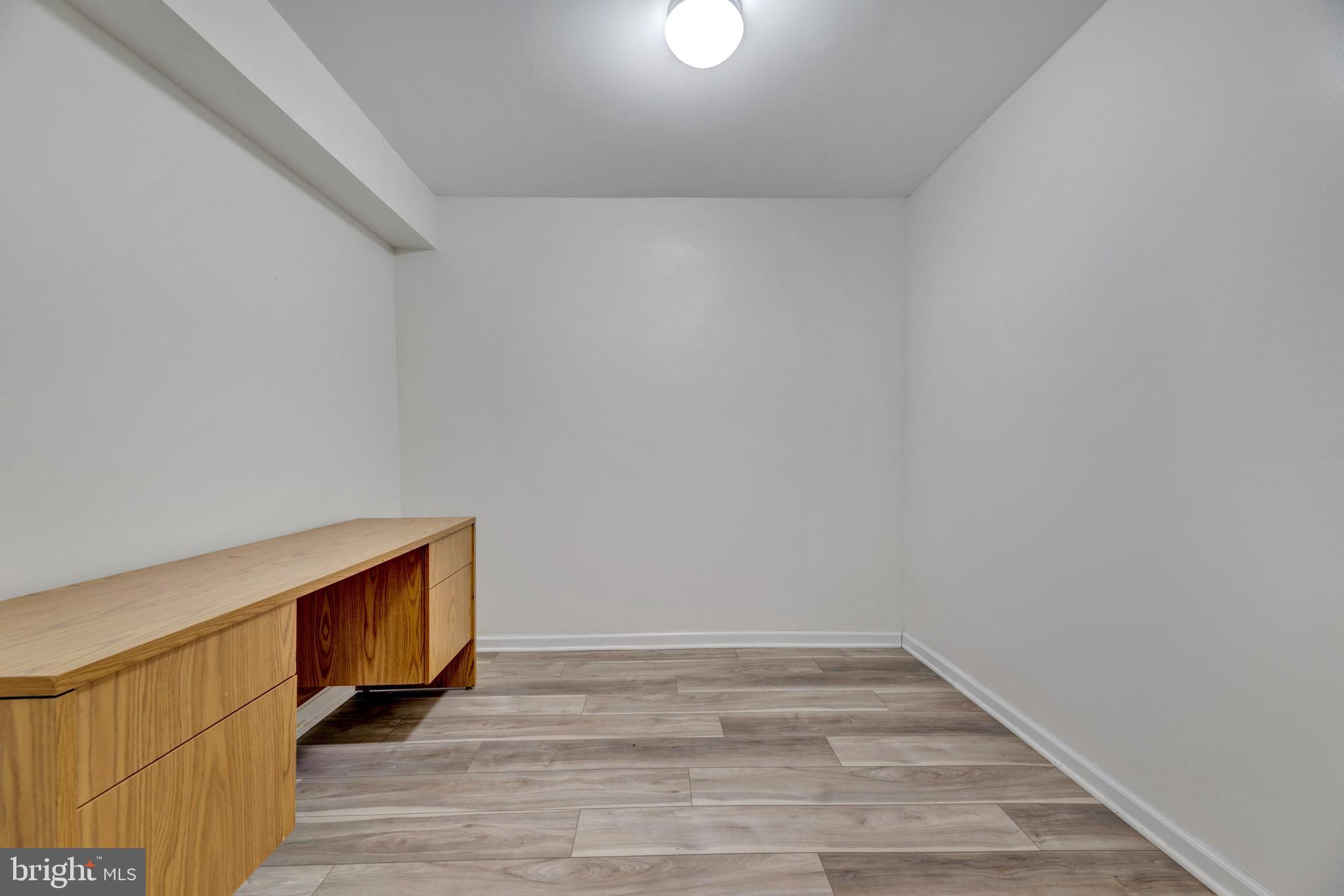 7108 Ruthgreen Road Windsor Mill, MD 21244 - Photo 24 of 25 a view of an empty room and wooden floor
