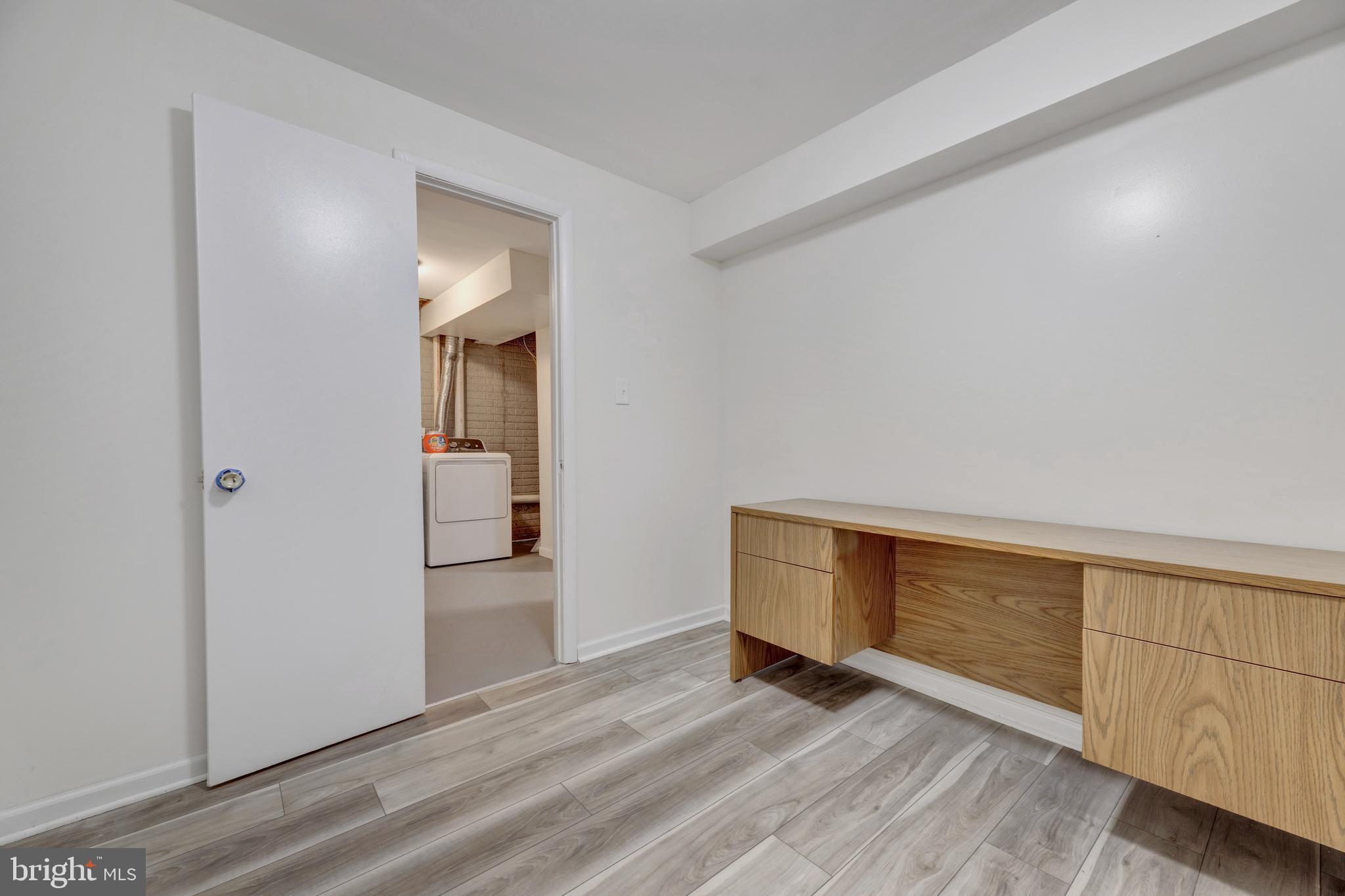 7108 Ruthgreen Road Windsor Mill, MD 21244 - Photo 25 of 25 a view of an empty room with wooden floor and cabinet