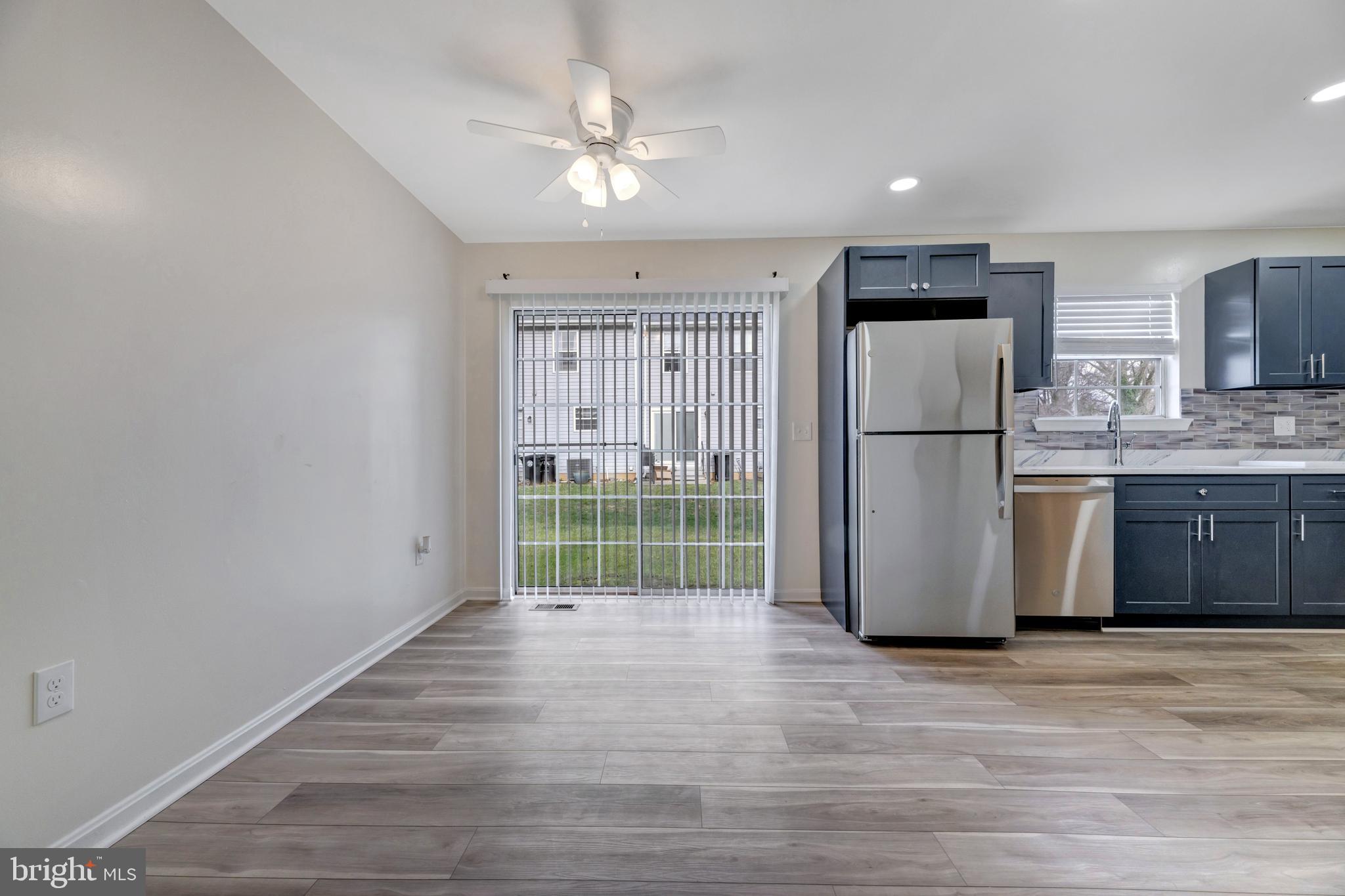 7108 Ruthgreen Road Windsor Mill, MD 21244 - Photo 10 of 25 a kitchen with stainless steel appliances a refrigerator and a fireplace