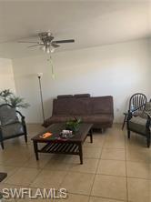 3325 Airport-Pulling Road North, Unit L1 Naples, FL 34105 - Photo 7 of 8 a living room with furniture a rug and white walls