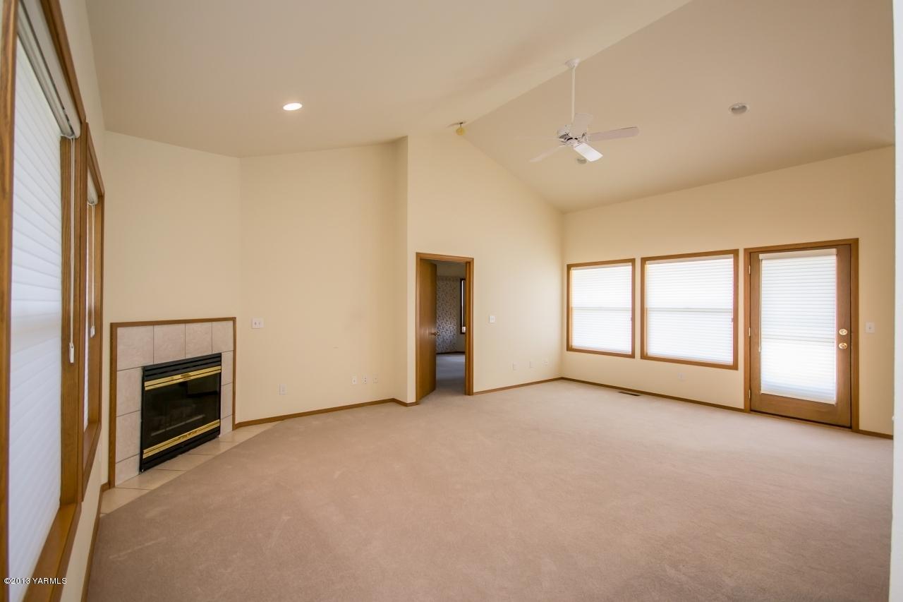 11814 Marble Road Yakima, WA 98908 - Photo 3 of 15 a view of an empty room with a fireplace and a window