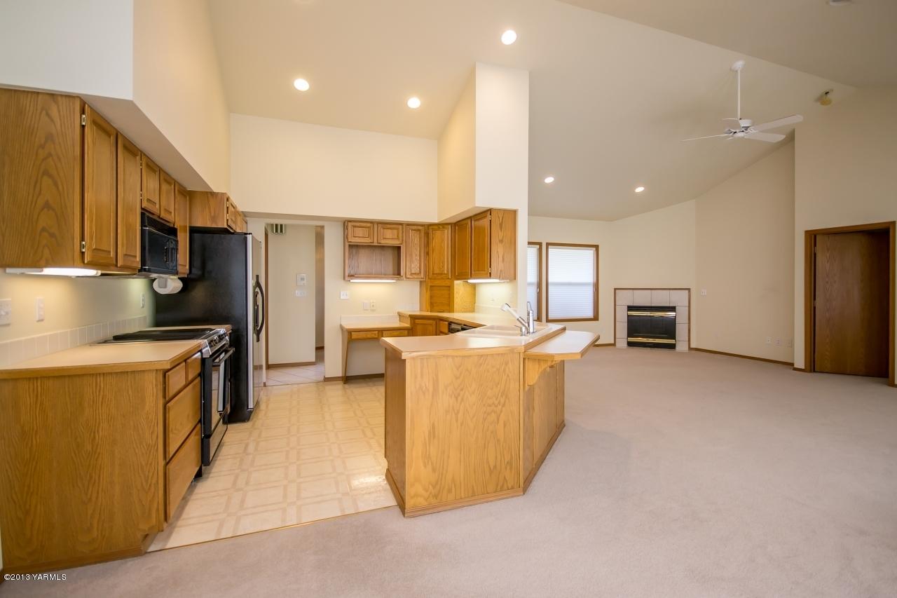 11814 Marble Road Yakima, WA 98908 - Photo 6 of 15 a large kitchen with kitchen island a sink a counter top space and stainless steel appliances