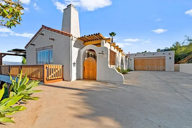 a view of a hallway with wooden floor and a living room