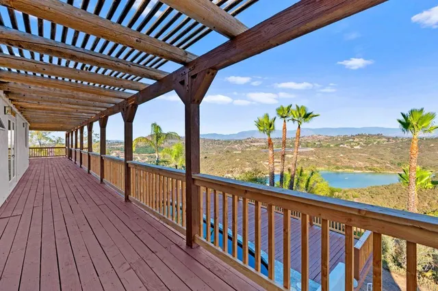 a view of a living room with kitchen view and wooden floor