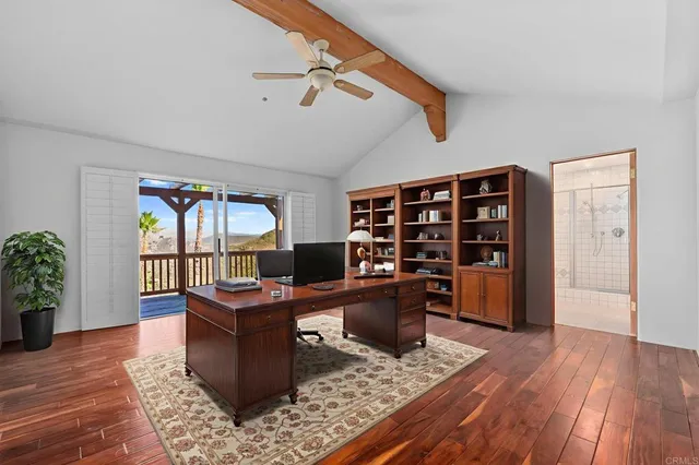 a large kitchen with stainless steel appliances kitchen island granite countertop a large counter top and a view of living room