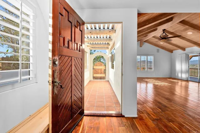 a kitchen with stainless steel appliances granite countertop a stove a sink dishwasher and a refrigerator with wooden floor