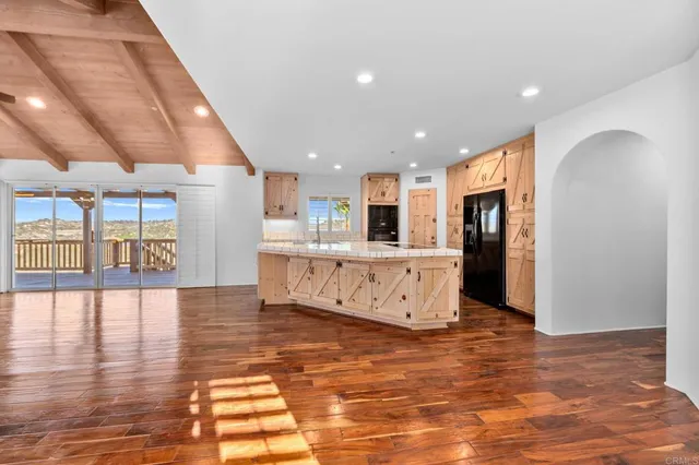 a view of a hallway with bedroom and wooden floor