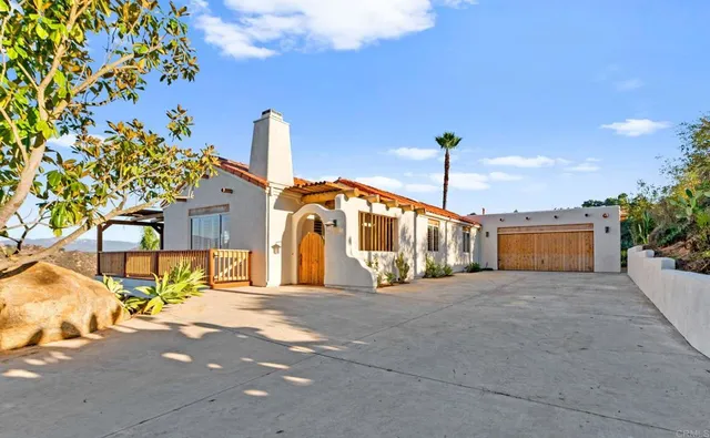 a view of a dining room with furniture and a kitchen