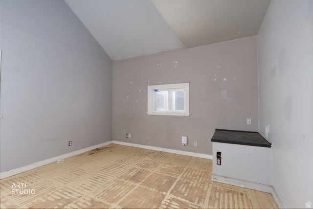 330 West 600th Street South Provo, UT 84601 - Photo 14 of 26 Vaulted ceiling room featuring light gray walls, a built-in corner structure with a dark countertop, and a window with white trim