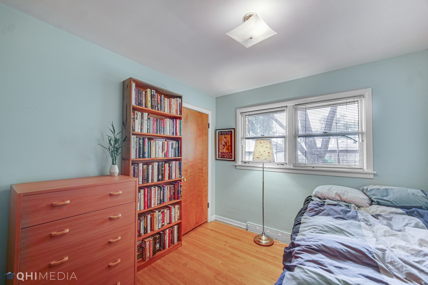1401 Birch Road Homewood, IL 60430 - Photo 14 of 22 a bedroom with a bed and a book shelf