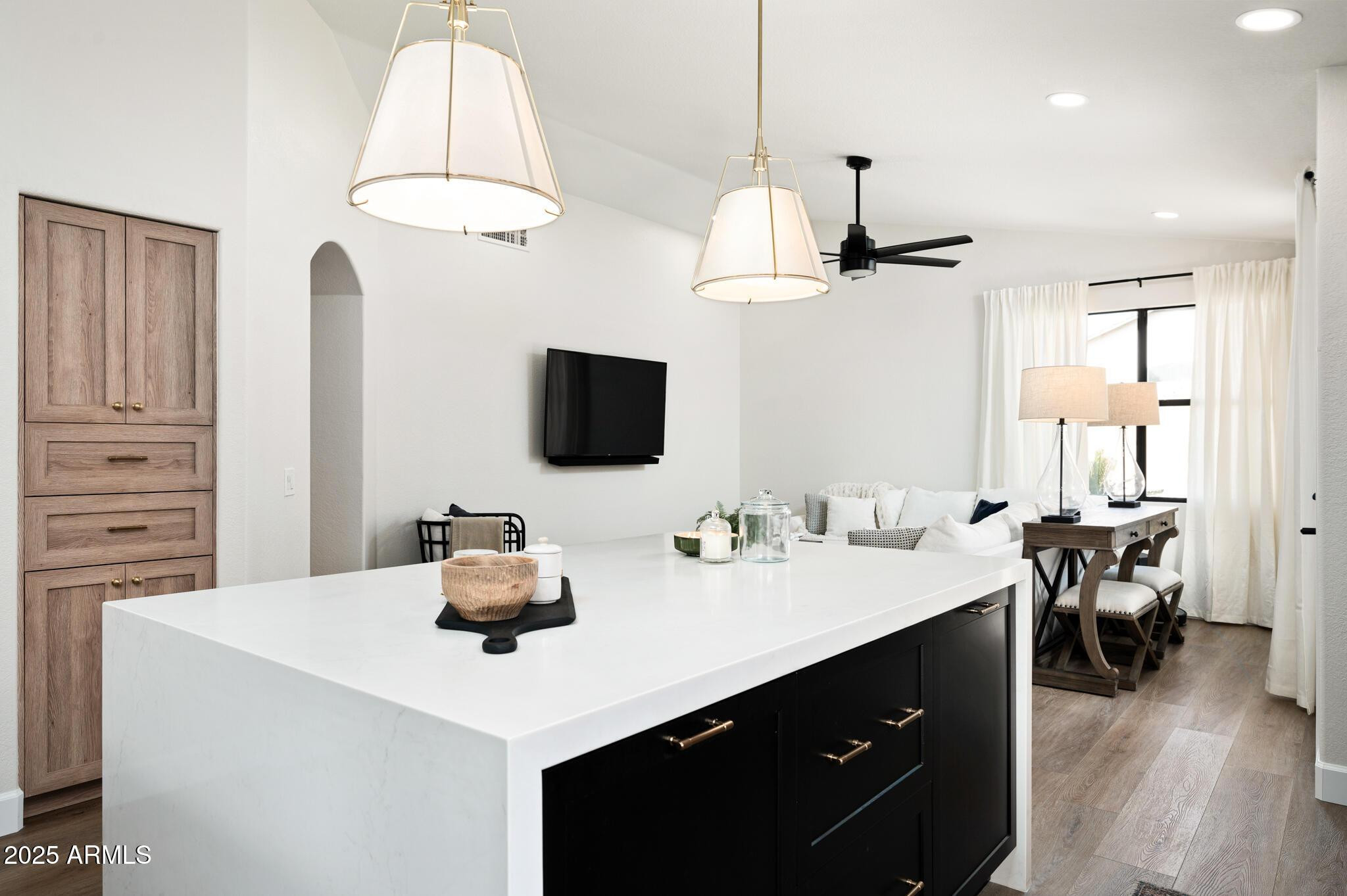 4706 East Jaeger Road Phoenix, AZ 85050 - Photo 13 of 30 a kitchen with a sink dishwasher a dining table and chairs with wooden floor