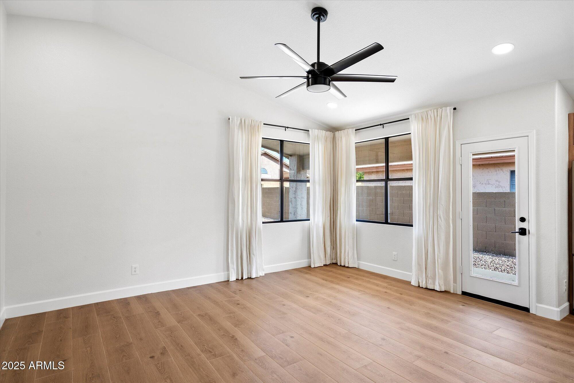 4706 East Jaeger Road Phoenix, AZ 85050 - Photo 14 of 30 a view of a big room with wooden floor closet and windows