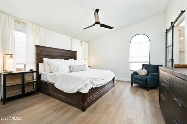 a bedroom with bed and a large window