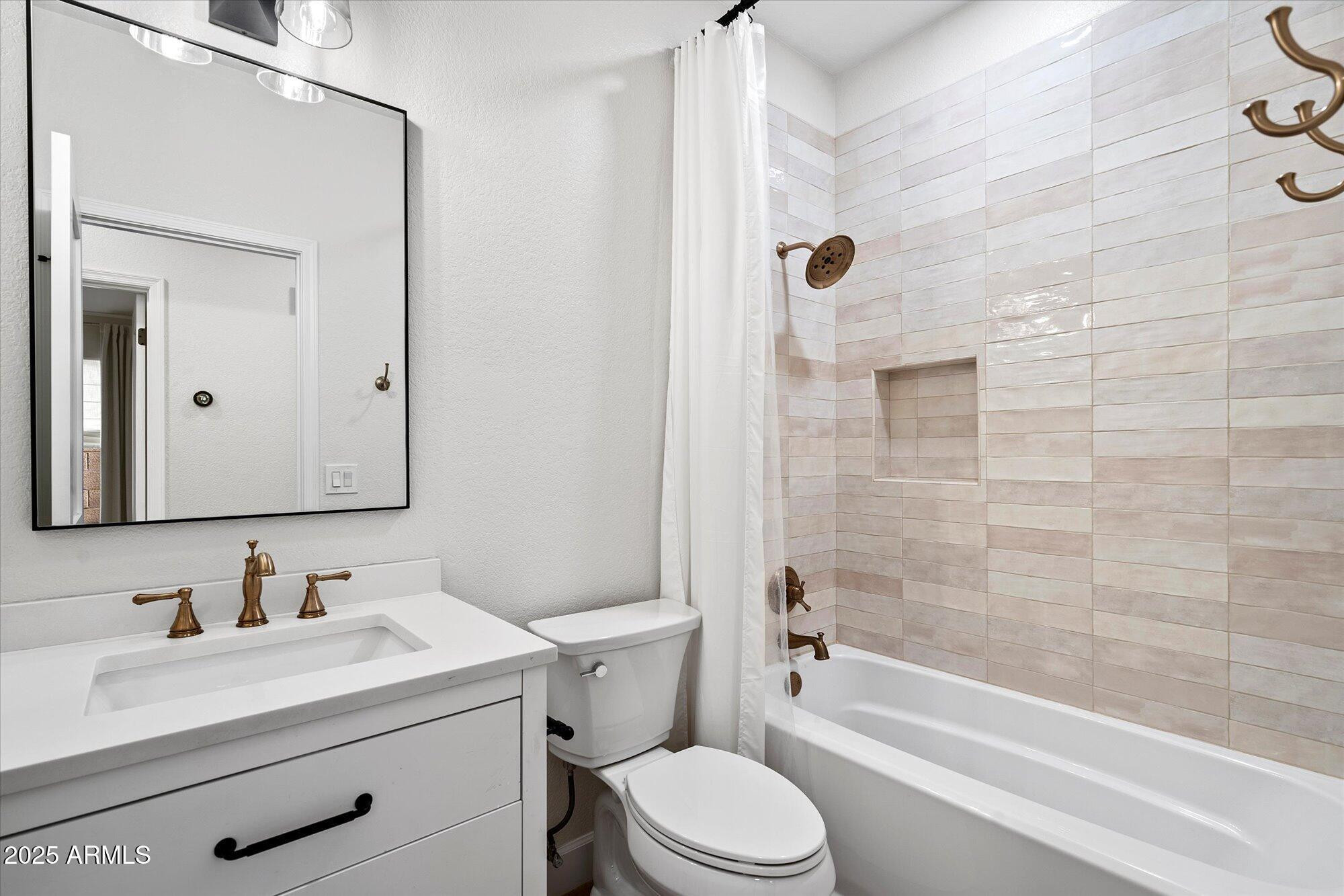 4706 East Jaeger Road Phoenix, AZ 85050 - Photo 24 of 30 a bathroom with a granite countertop sink a toilet and shower