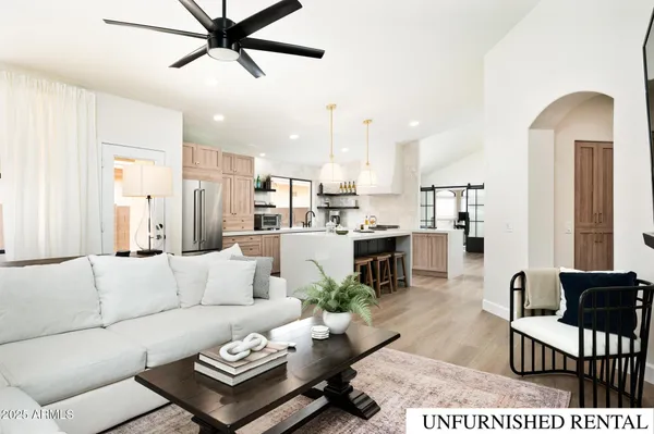 a living room with furniture and kitchen view